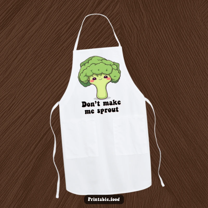 Funny apron featuring a shy broccoli floret peeking shyly from a leaf, perfect for the bashful cook.