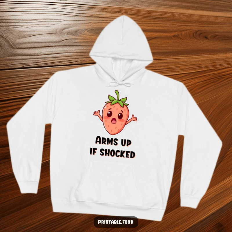 Funny surprised strawberry character with tiny arms outstretched on a comfortable hoodie, ideal for cozy fruity humor.